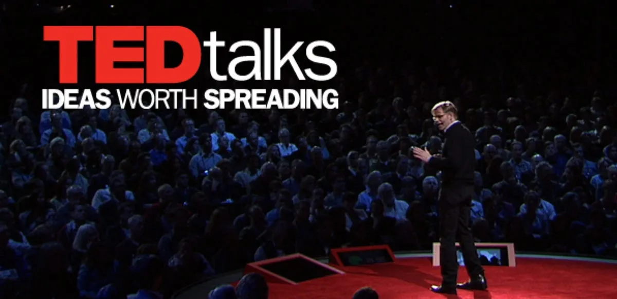 Escenario de TED con conferenciante presentando una charla sobre liderazgo